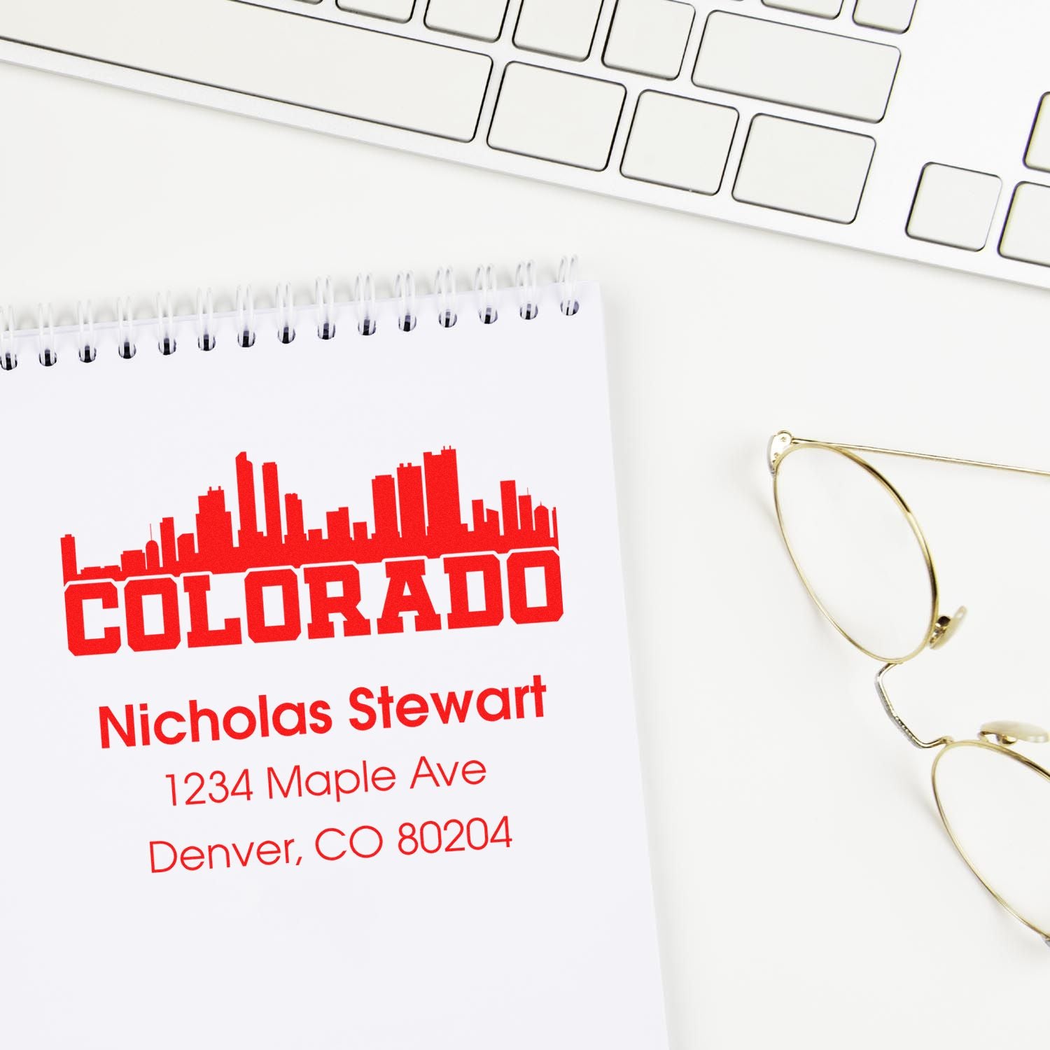 Custom Colorado address rubber stamp with city skyline, Nicholas Stewart name, and Denver, CO 80204 return address.