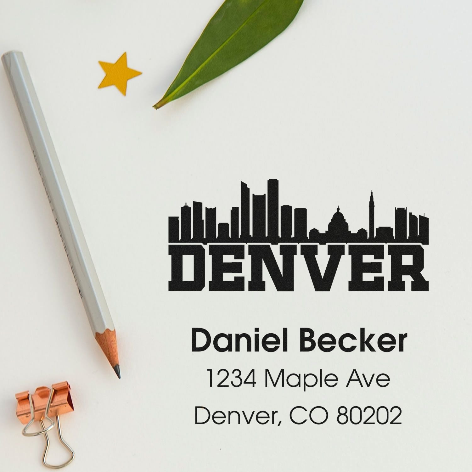Custom Denver address rubber stamp with skyline design for Daniel Becker, featuring 1234 Maple Ave, Denver, CO 80202.