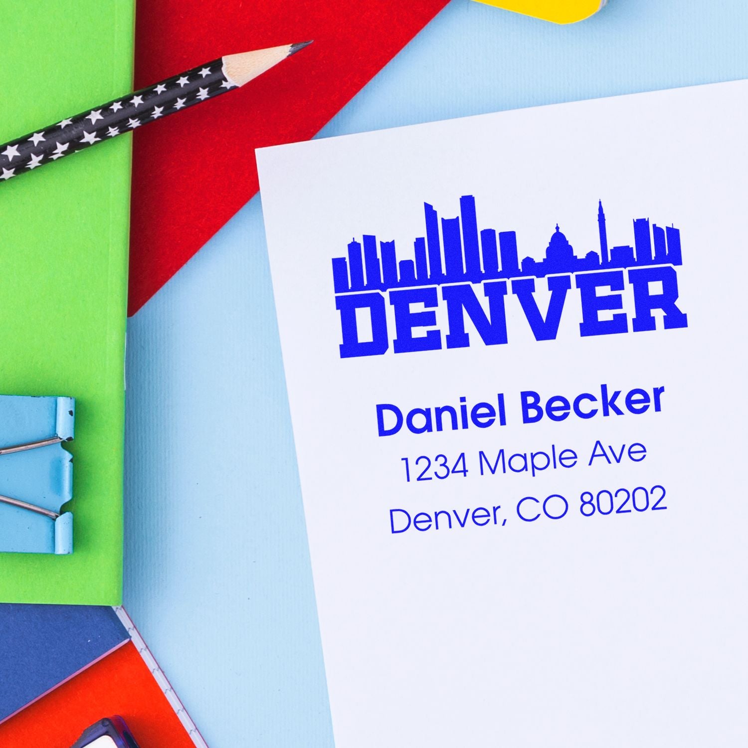 Custom Denver address rubber stamp with skyline design for Daniel Becker, 1234 Maple Ave, Denver, CO 80202.