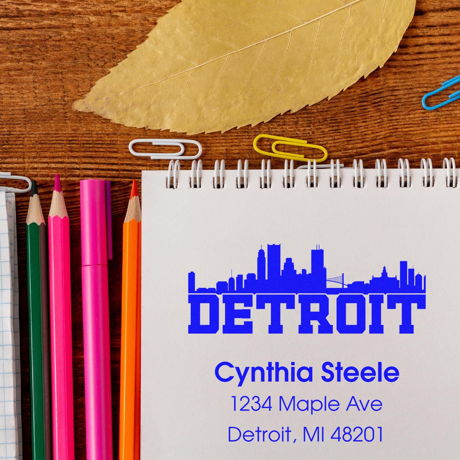 Custom Detroit return address rubber stamp impression on notebook, featuring skyline design and Cynthia Steele address.