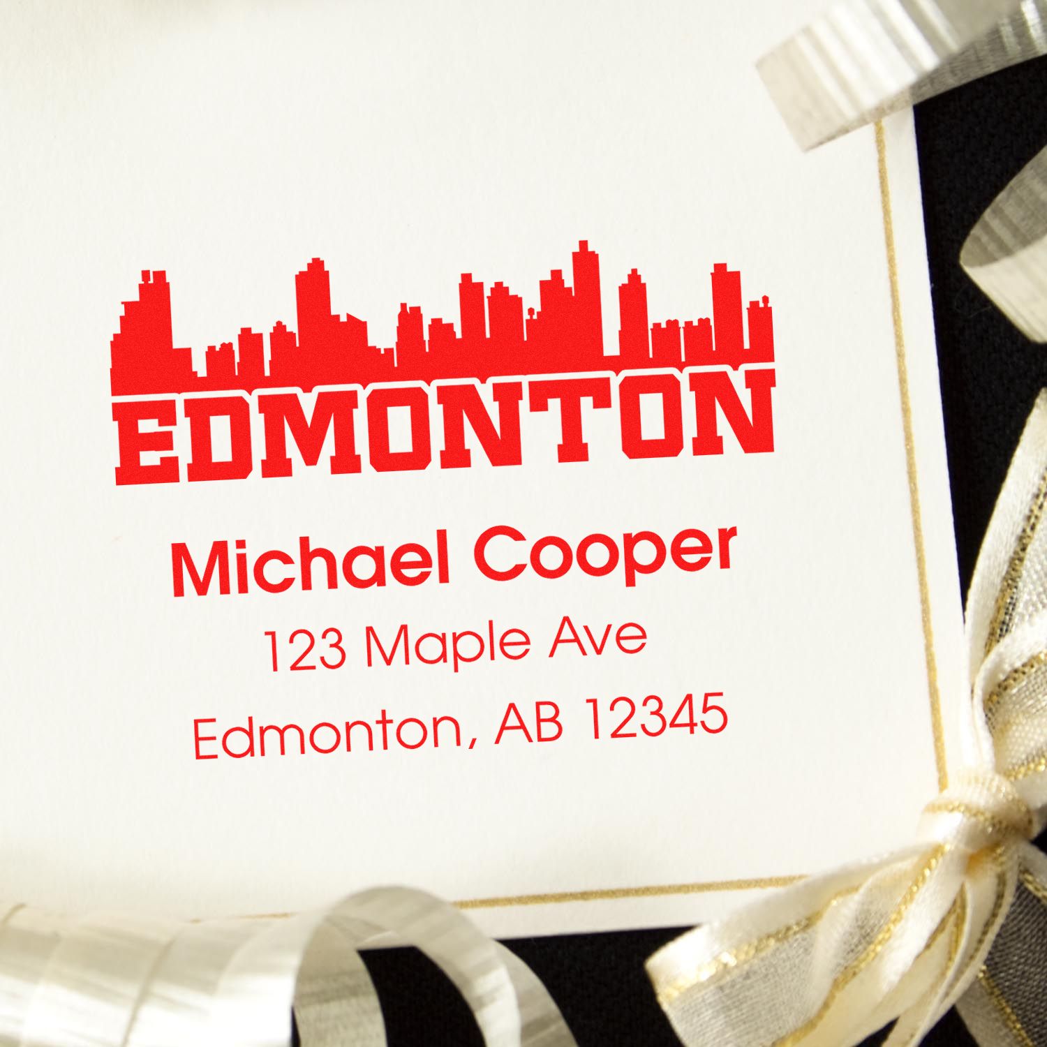 Custom Edmonton return address rubber stamp with skyline logo, Michael Cooper name, and mailing address.