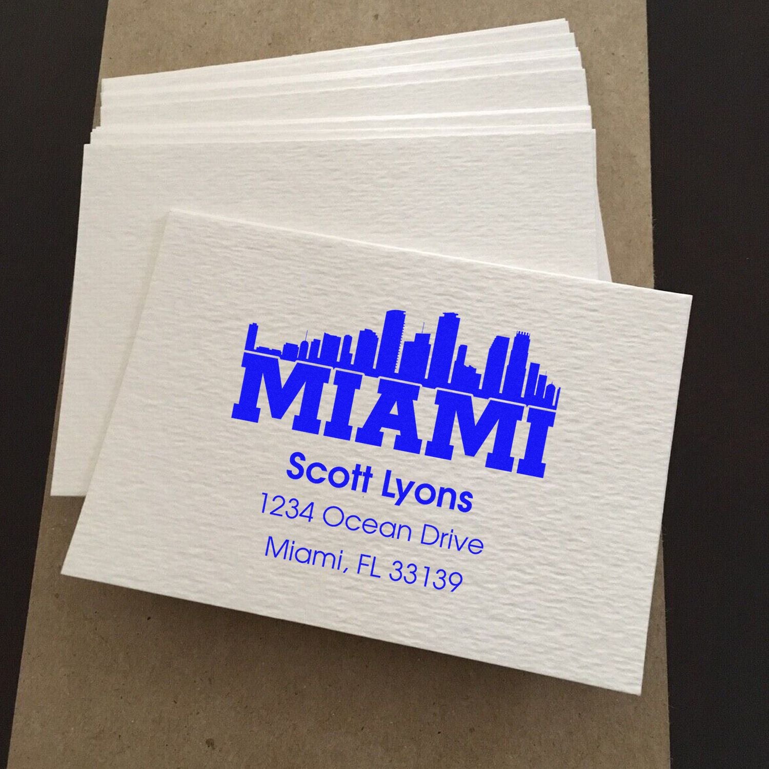 Custom Miami address rubber stamp design printed on white napkins for branded business packaging.