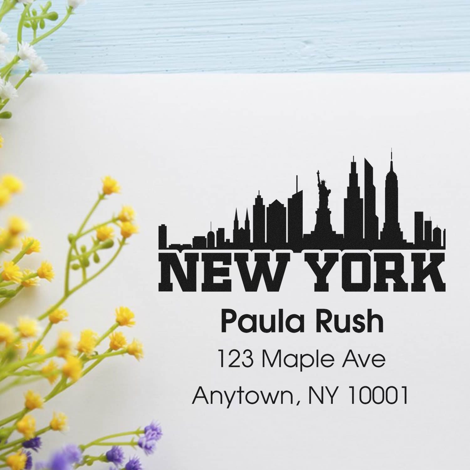 Custom New York skyline return address rubber stamp with Paula Rush name and address for personalized mailing.