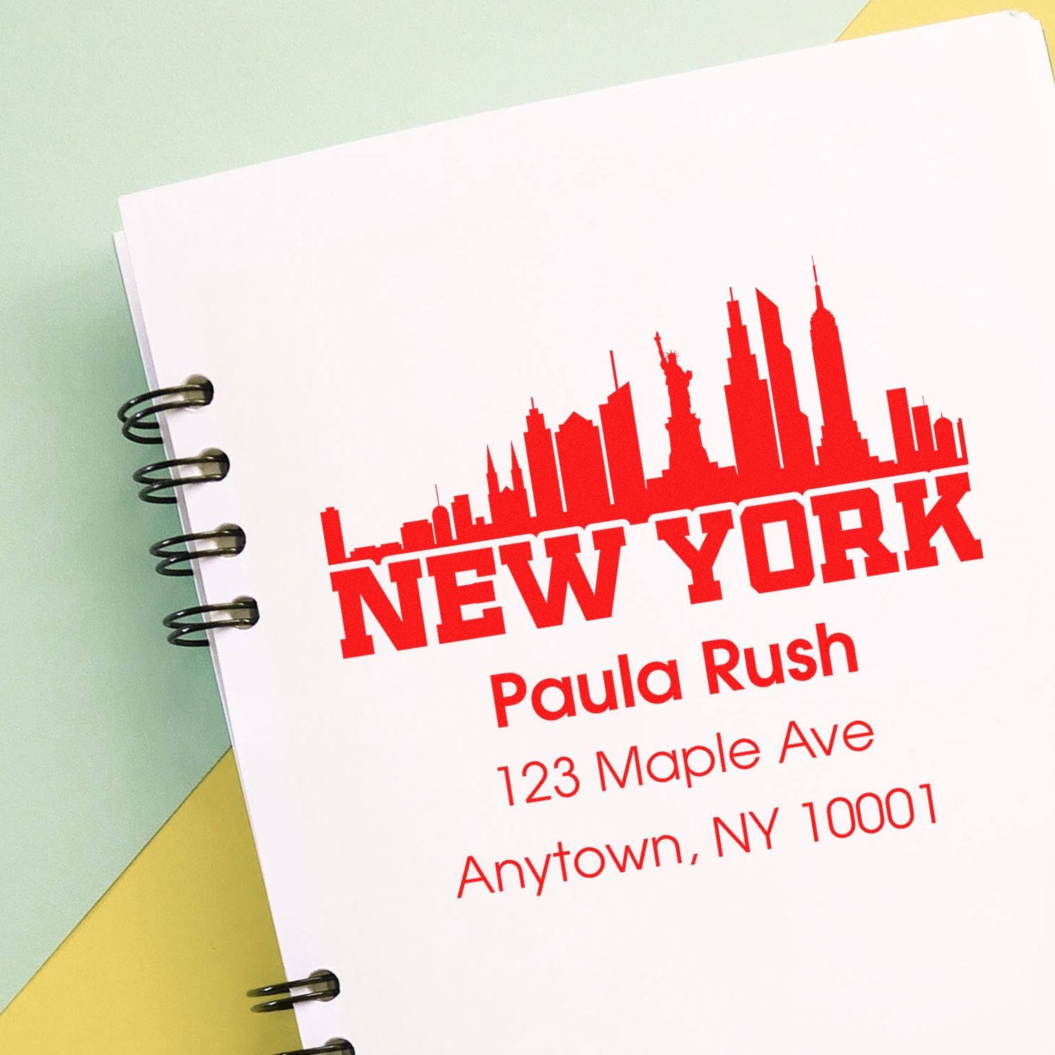 Custom New York return address rubber stamp with skyline design for Paula Rush, 123 Maple Ave, Anytown, NY 10001.