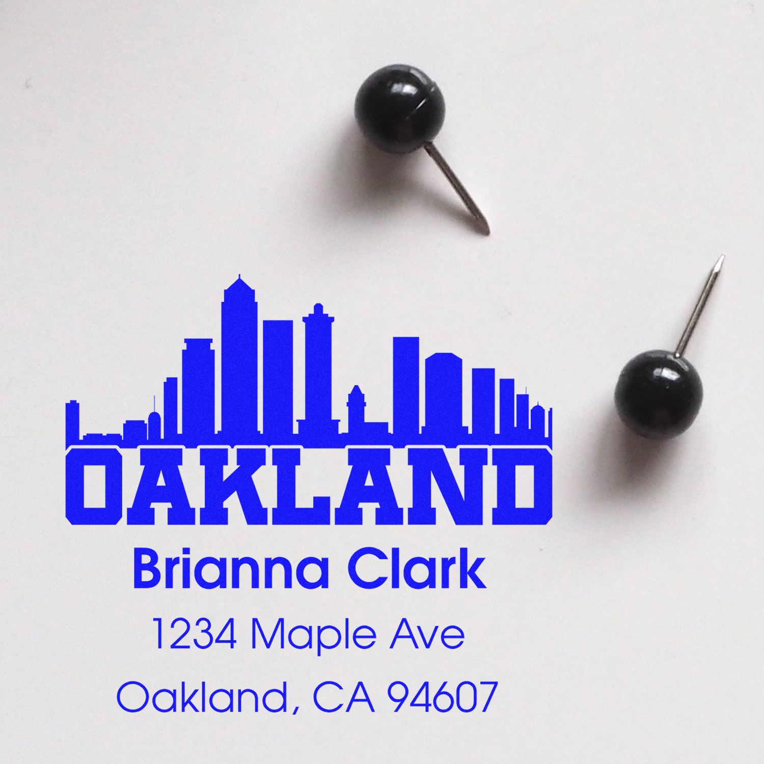 Custom Oakland address rubber stamp with skyline design for Brianna Clark, 1234 Maple Ave, Oakland, CA 94607.