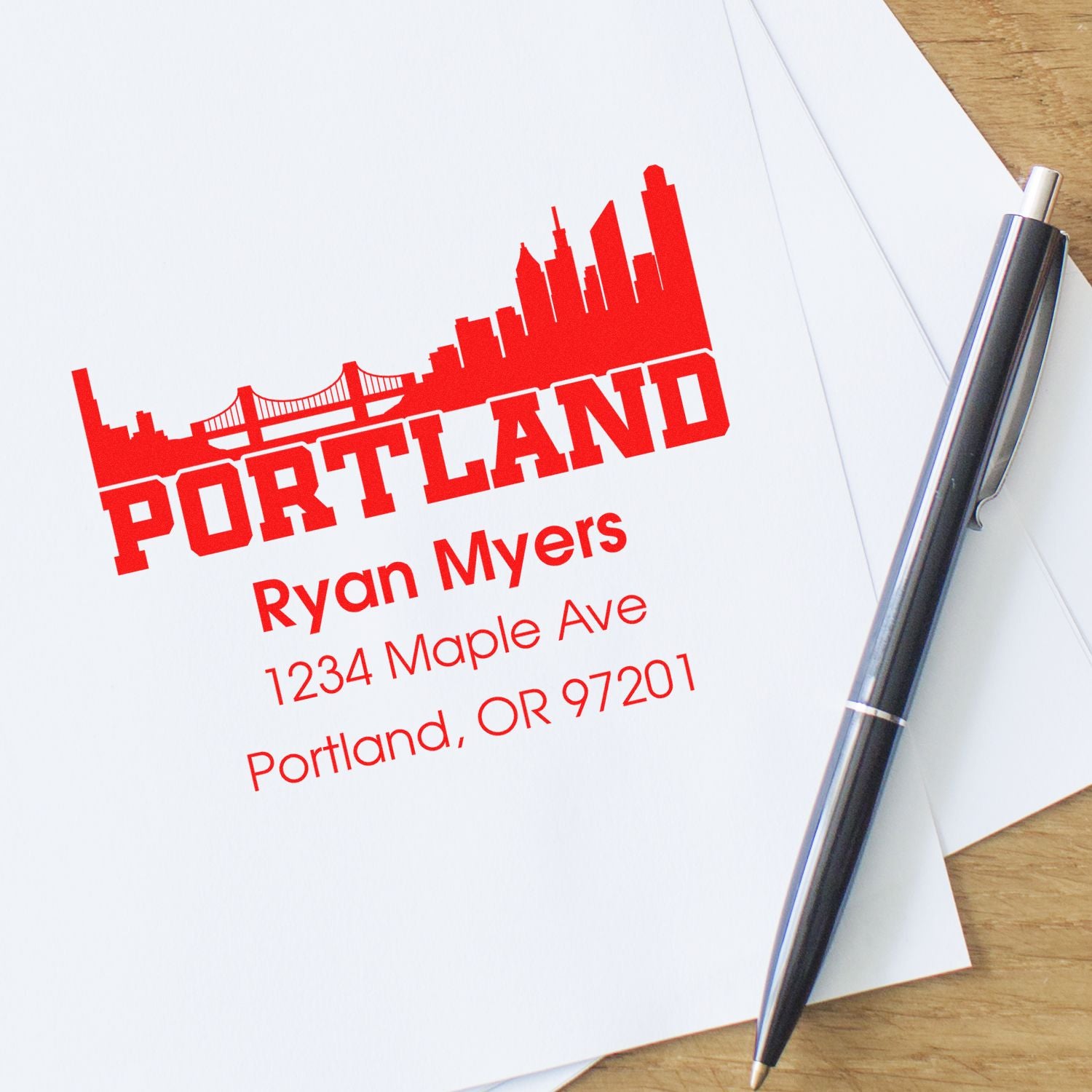 Custom Portland return address rubber stamp with skyline design, personalized name, and address for envelopes.