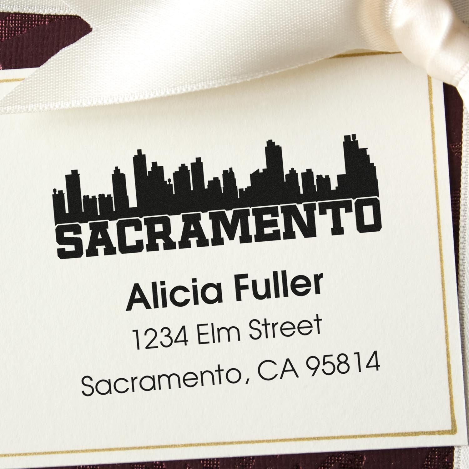 Custom Sacramento address rubber stamp with skyline design, showing Alicia Fuller, 1234 Elm Street, CA 95814 for return mail.