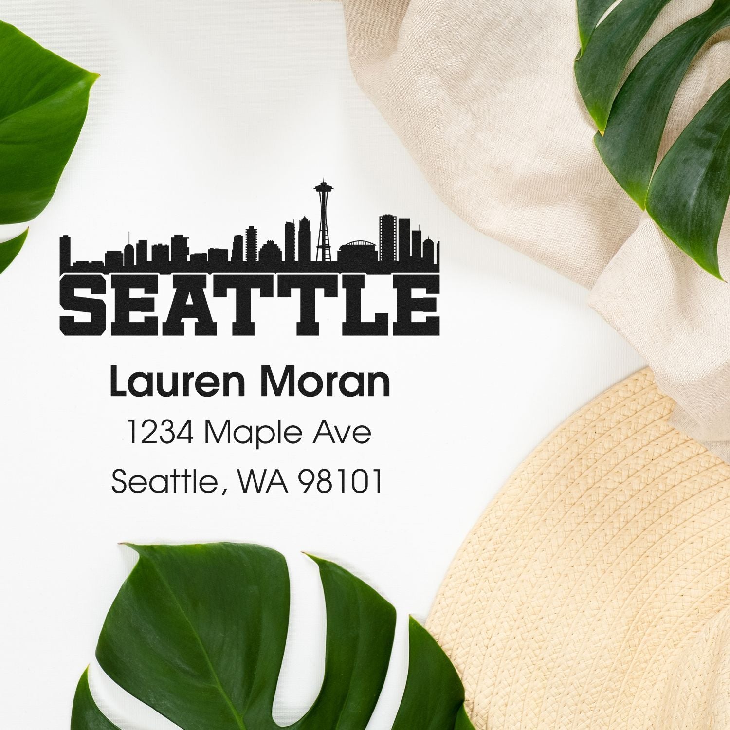 Personalized Seattle skyline address rubber stamp for Lauren Moran, 1234 Maple Ave, Seattle, WA 98101.