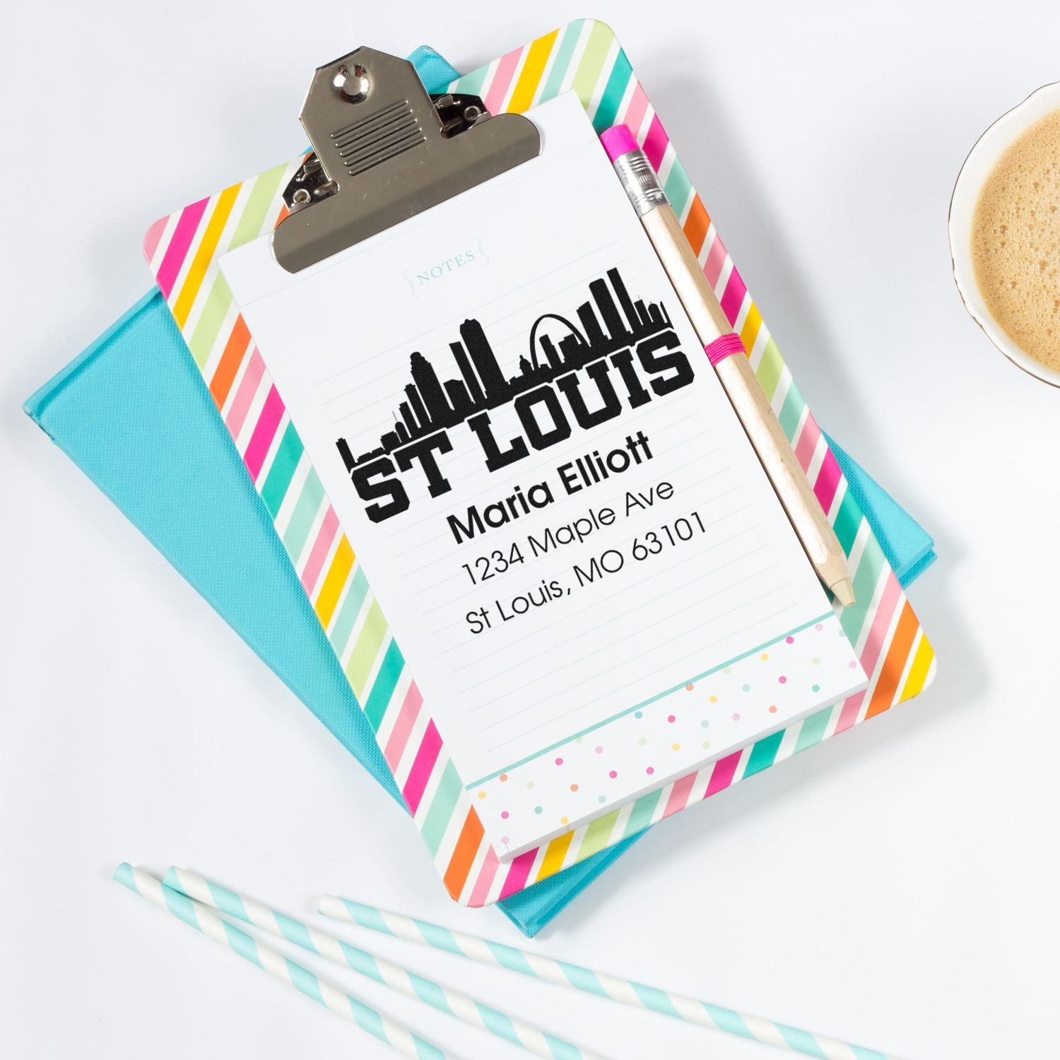 Custom St. Louis address rubber stamp design on clipboard with colorful stationery.