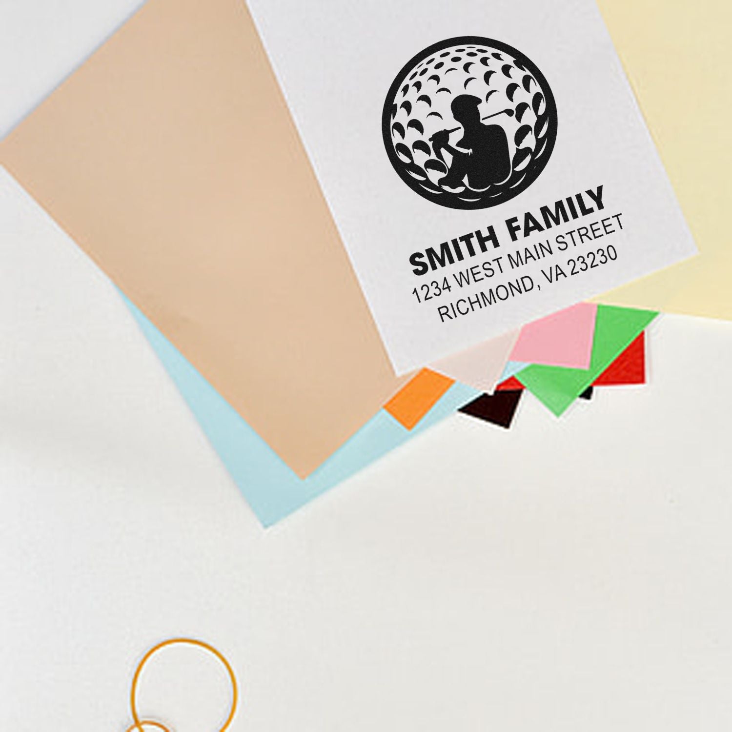 Custom family address rubber stamp on envelopes, with golf-themed design for personalized return addressing.