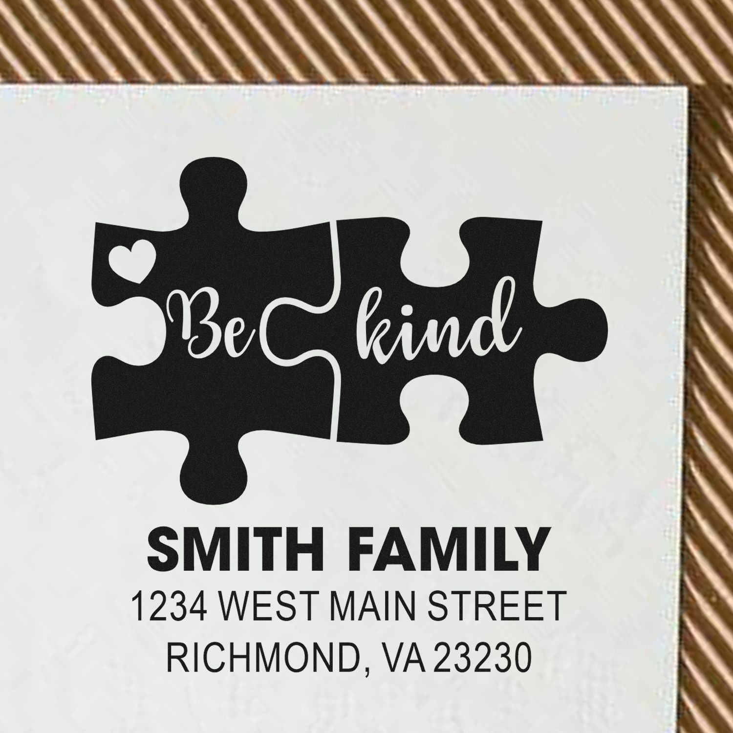 Custom rubber stamp with Be Kind puzzle design, Smith Family name, and return address for personalized mailing labels.