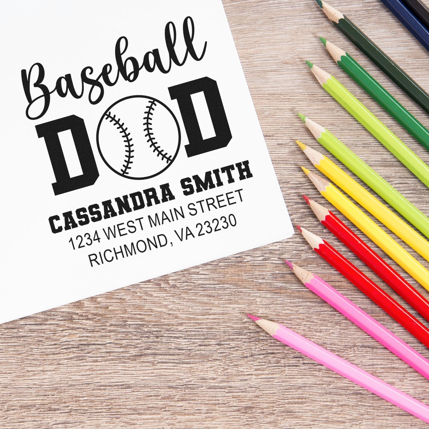 Custom baseball dad rubber stamp design with name and address, featuring a baseball graphic on white paper with colored pencils.