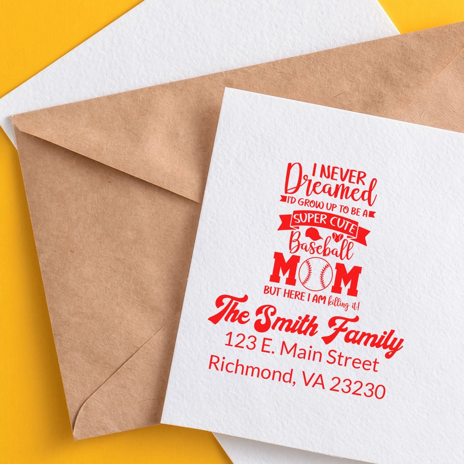 Custom return address rubber stamp design on kraft envelope with baseball mom family name and address in red.