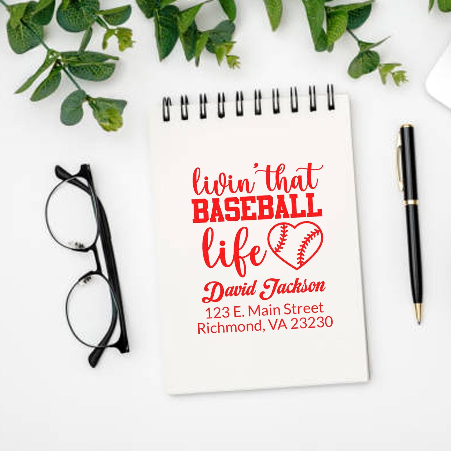 Custom baseball life rubber stamp mockup on notebook with name and address for personalized sports stationery.