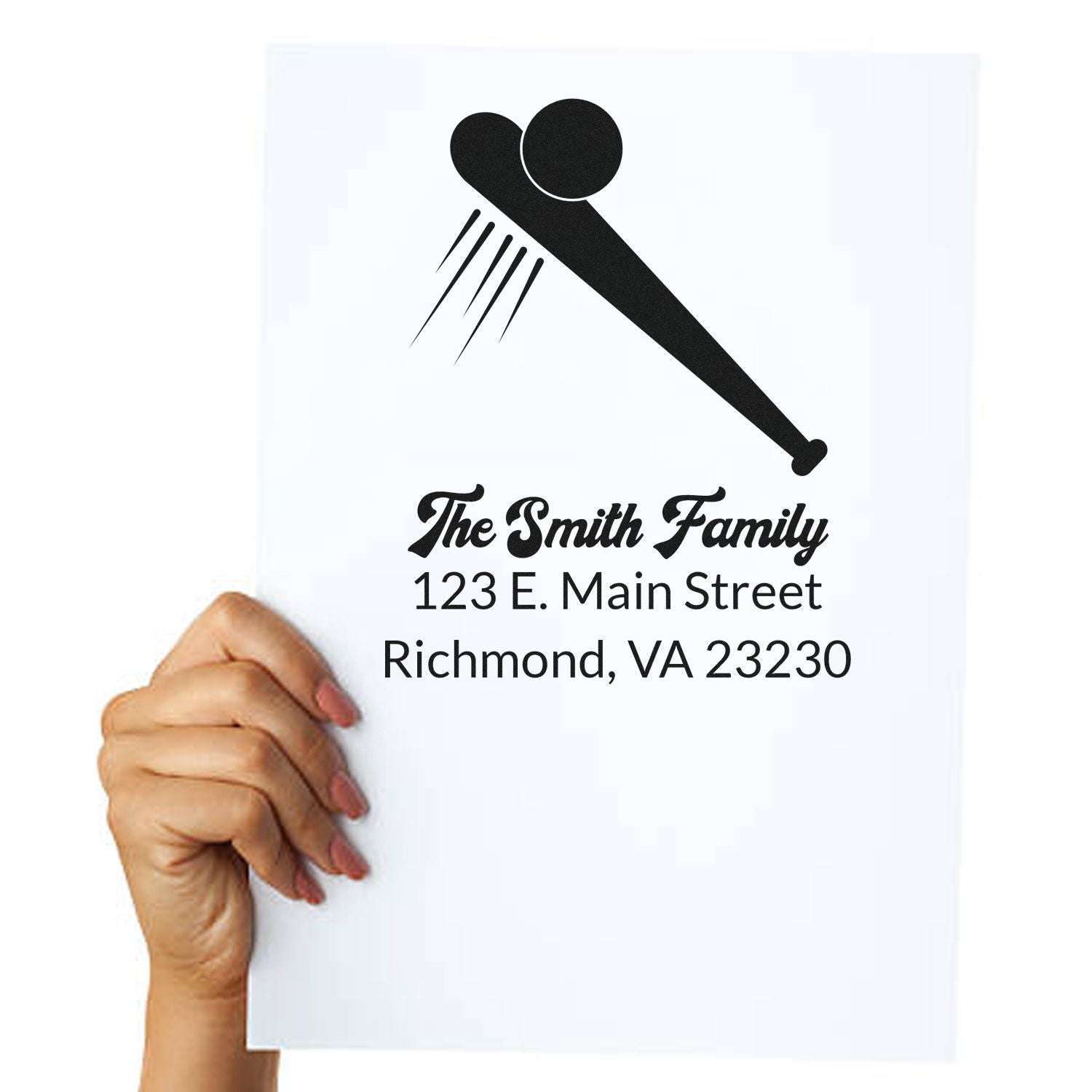 Custom return address rubber stamp with family name, street address, and monogram logo for mailing envelopes.
