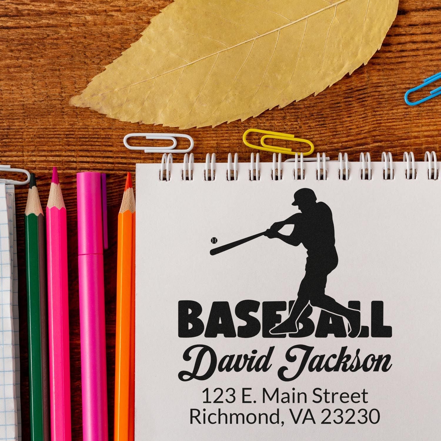 Custom baseball rubber stamp with player silhouette, David Jackson name, and return address on a notebook.