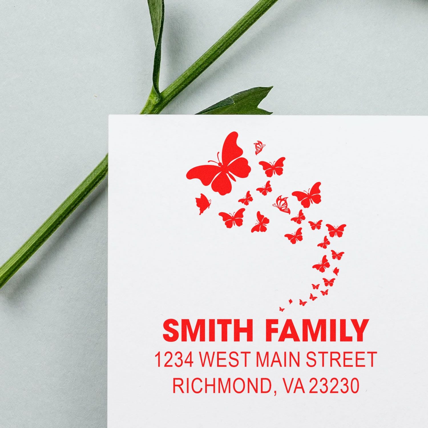 Custom butterfly return address rubber stamp for Smith Family, Richmond VA, with decorative red butterflies.