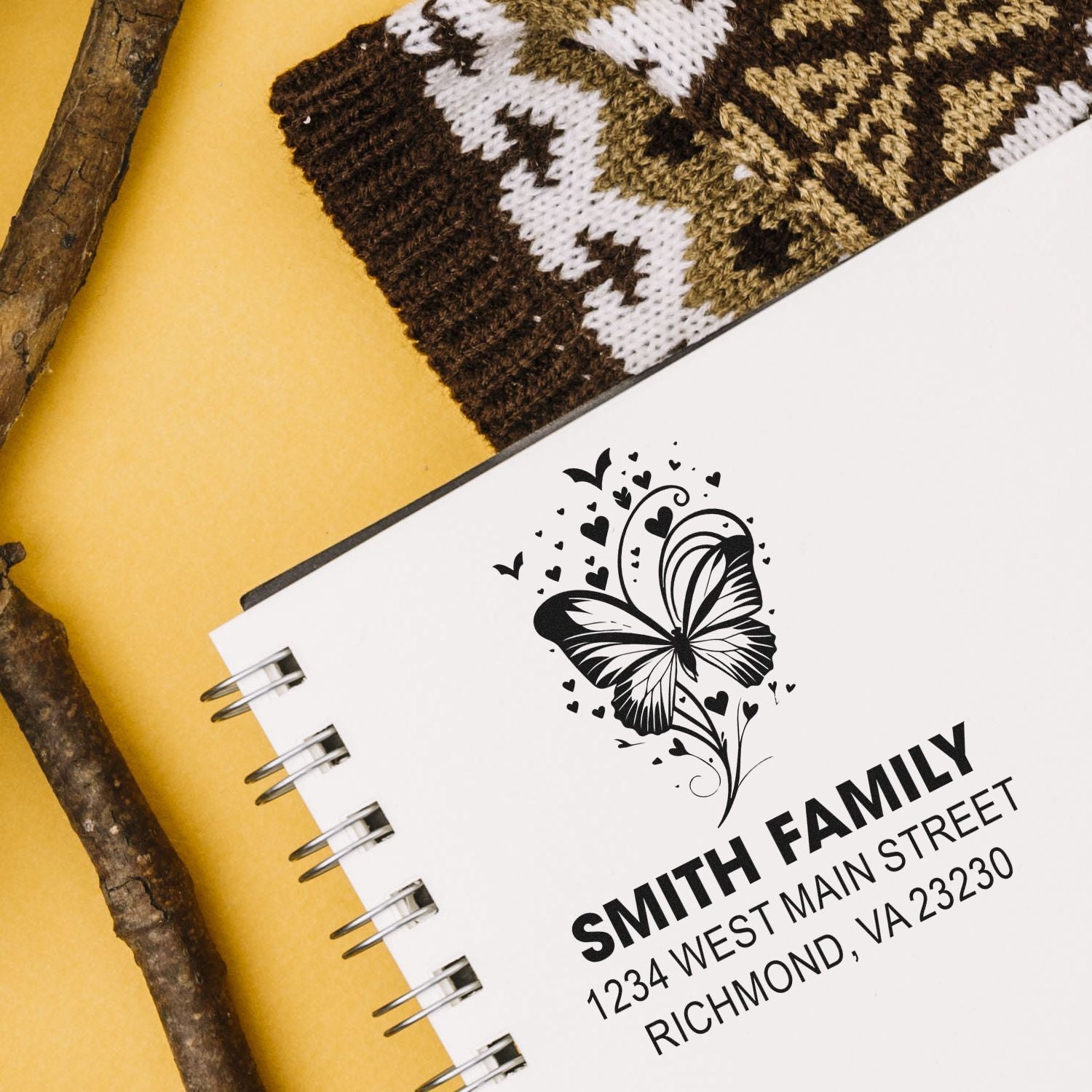Custom rubber stamp design with butterfly and family name address for personalized stationery and mailing.