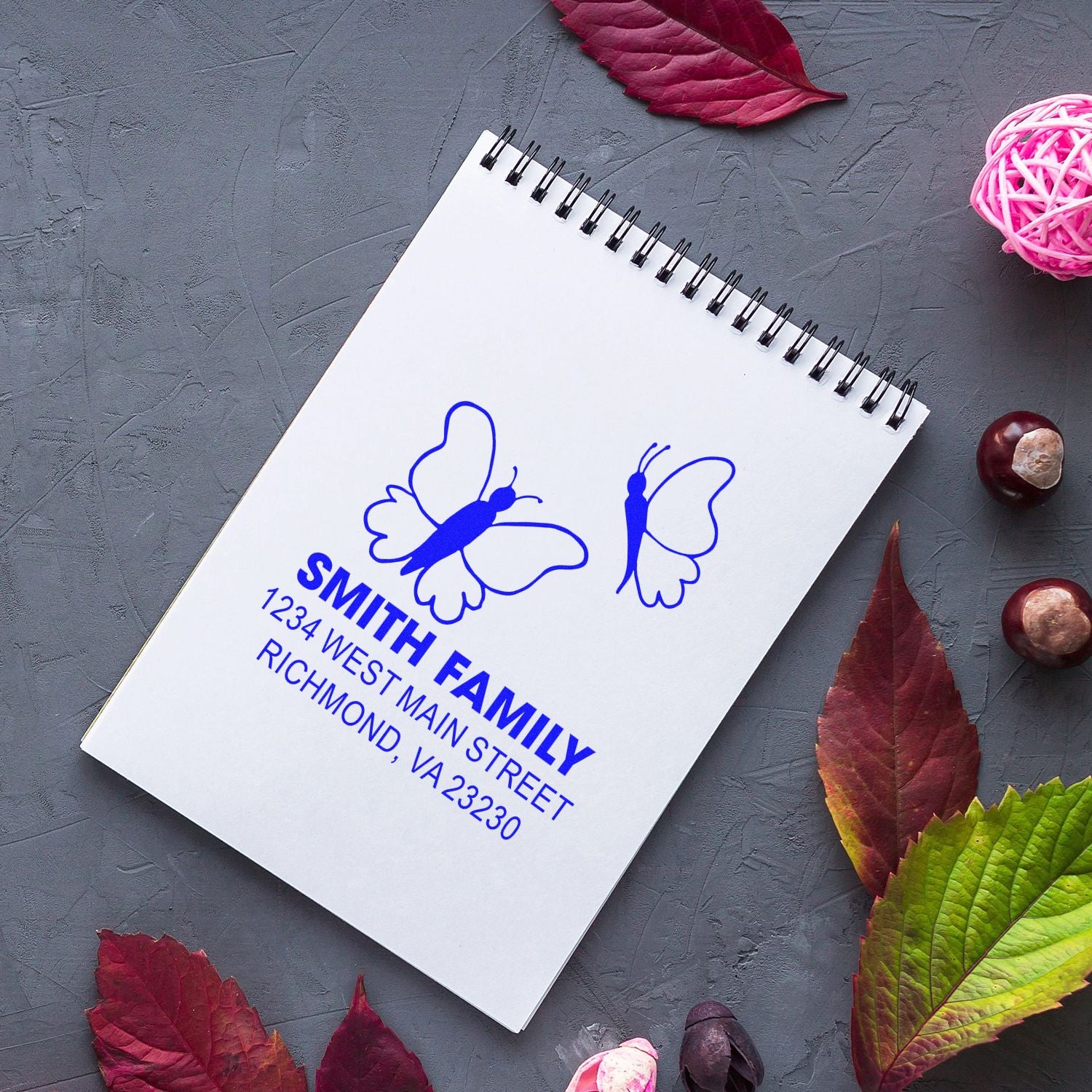 Custom butterfly address rubber stamp for the Smith Family, featuring name and Richmond, VA address on a notebook.