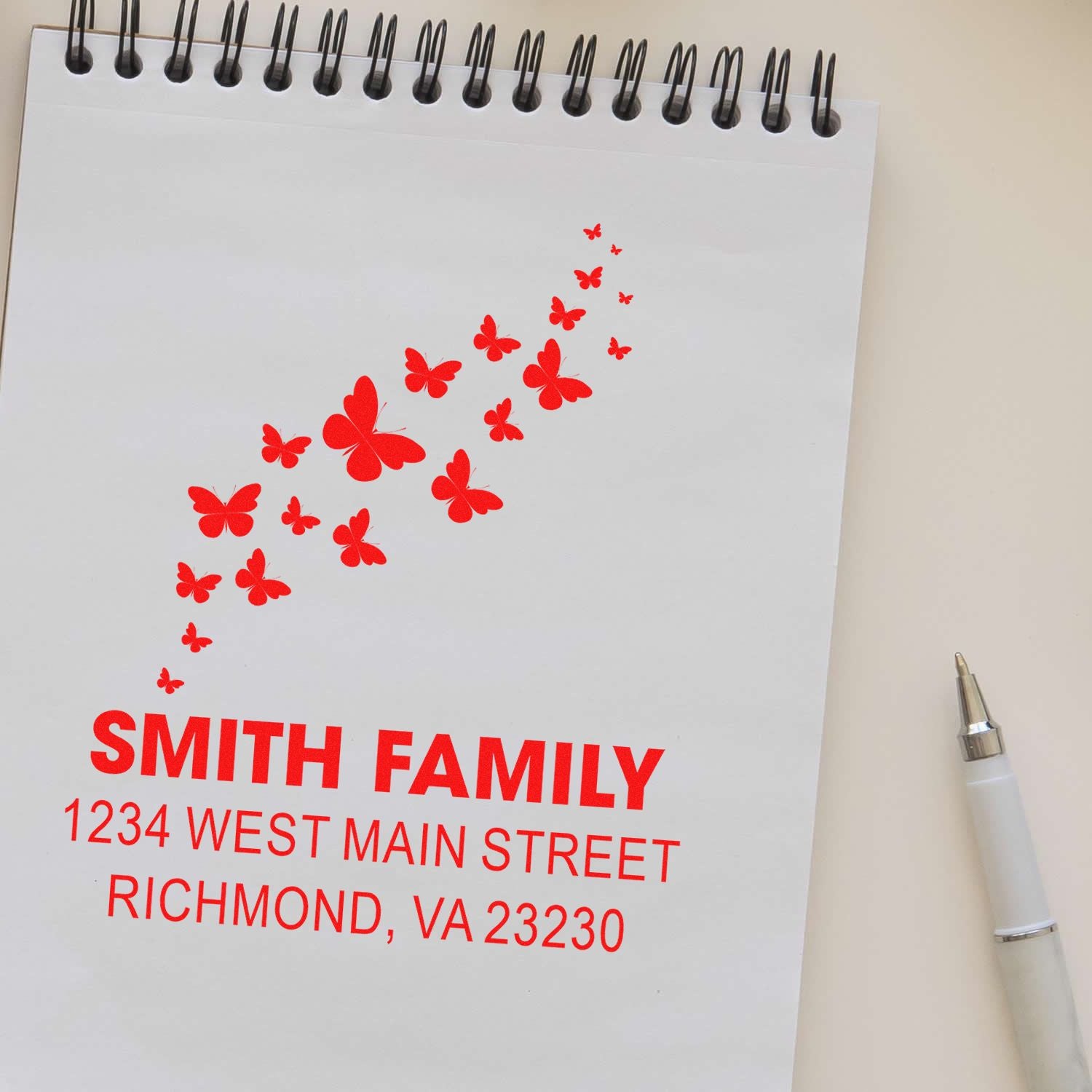Custom butterfly return address rubber stamp for Smith family, Richmond, VA, in bright red ink.