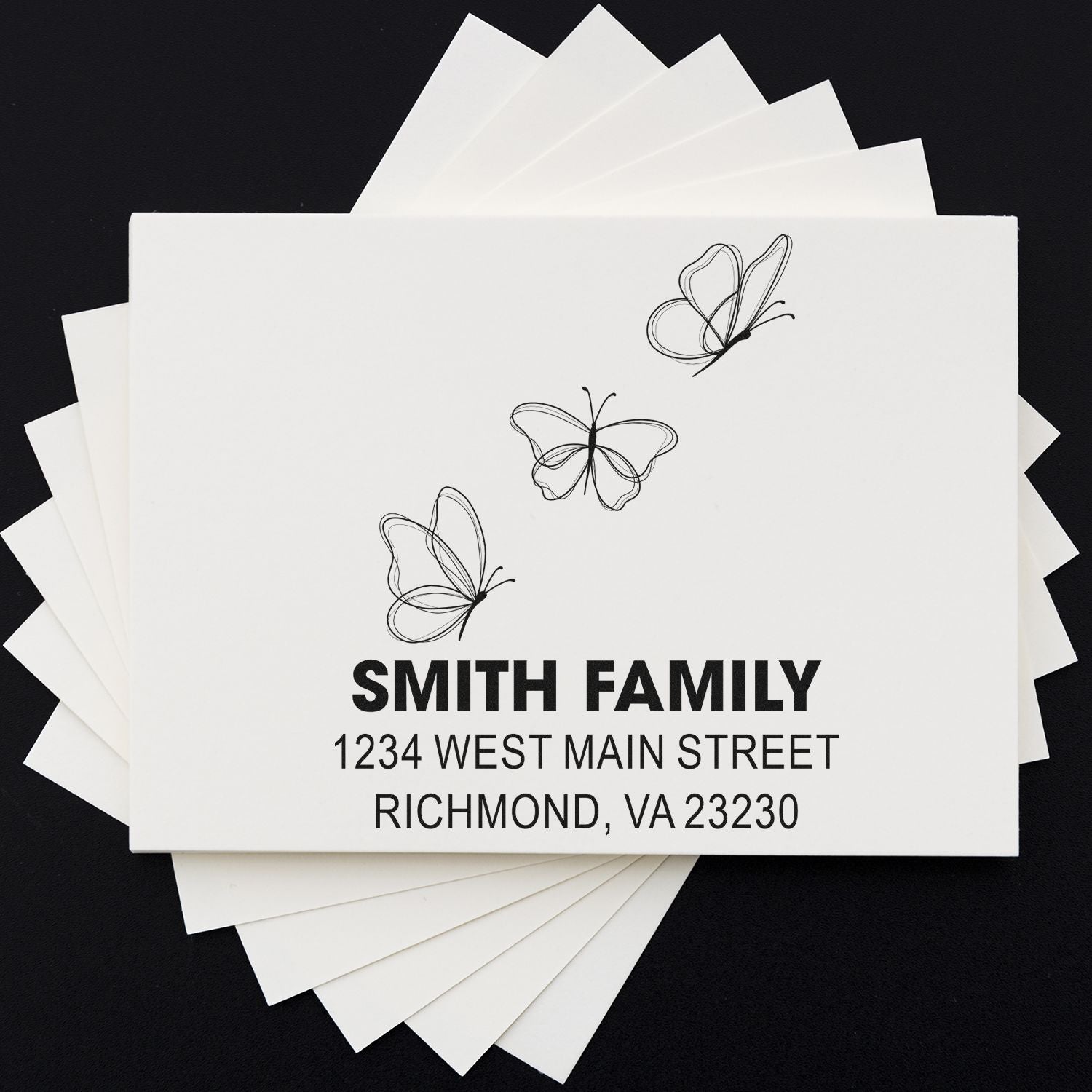 Custom return address rubber stamp with butterflies for Smith Family, featuring 1234 West Main Street, Richmond, VA 23230.