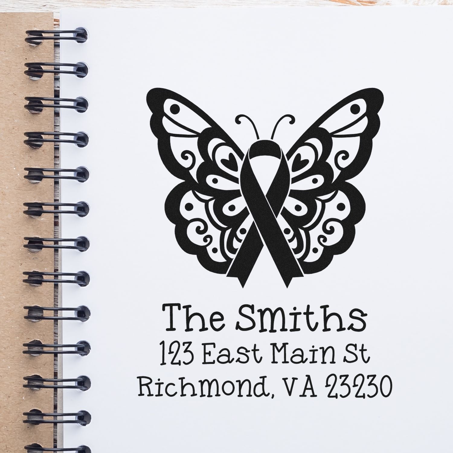 Custom butterfly ribbon rubber stamp with family name and address for mailing, gifts, or stationery.