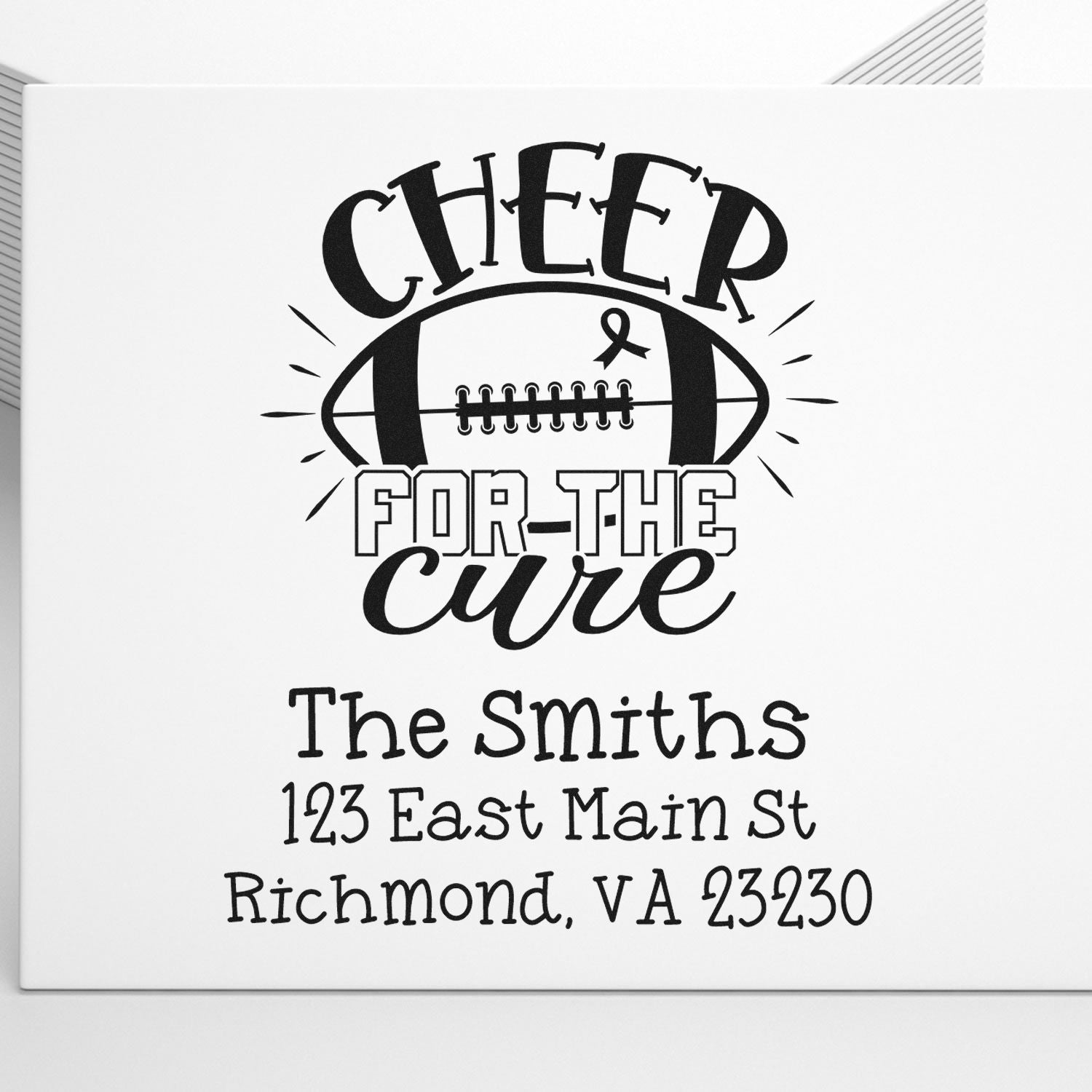 Custom rubber stamp design reading Cheer for the Cure with football, ribbon, and personalized return address for The Smiths.
