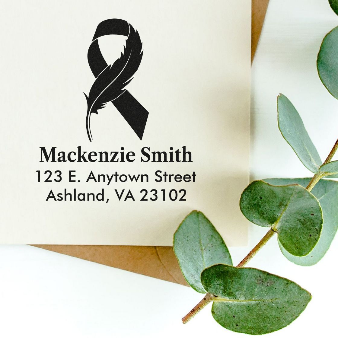 Custom rubber stamp with black ribbon and feather design for return address envelopes and memorial stationery.
