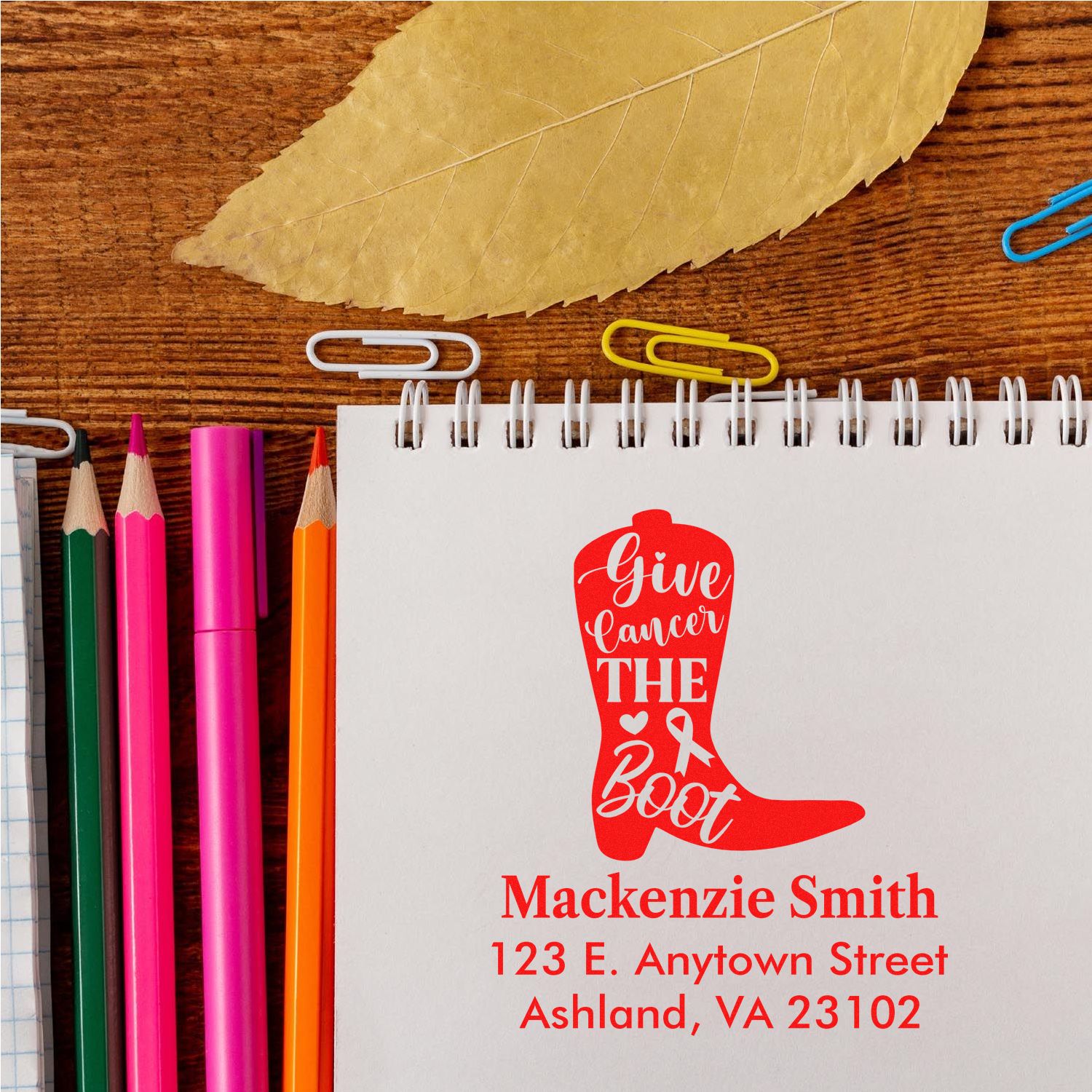 Custom rubber stamp design with Give Cancer the Boot red boot logo, name, and address for cancer awareness stationery.