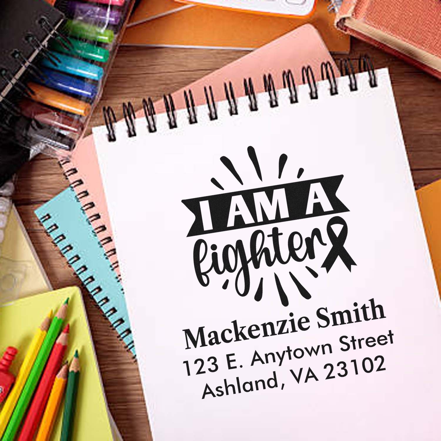Custom rubber stamp mockup reading I Am a Fighter with breast cancer ribbon and personalized name and address.