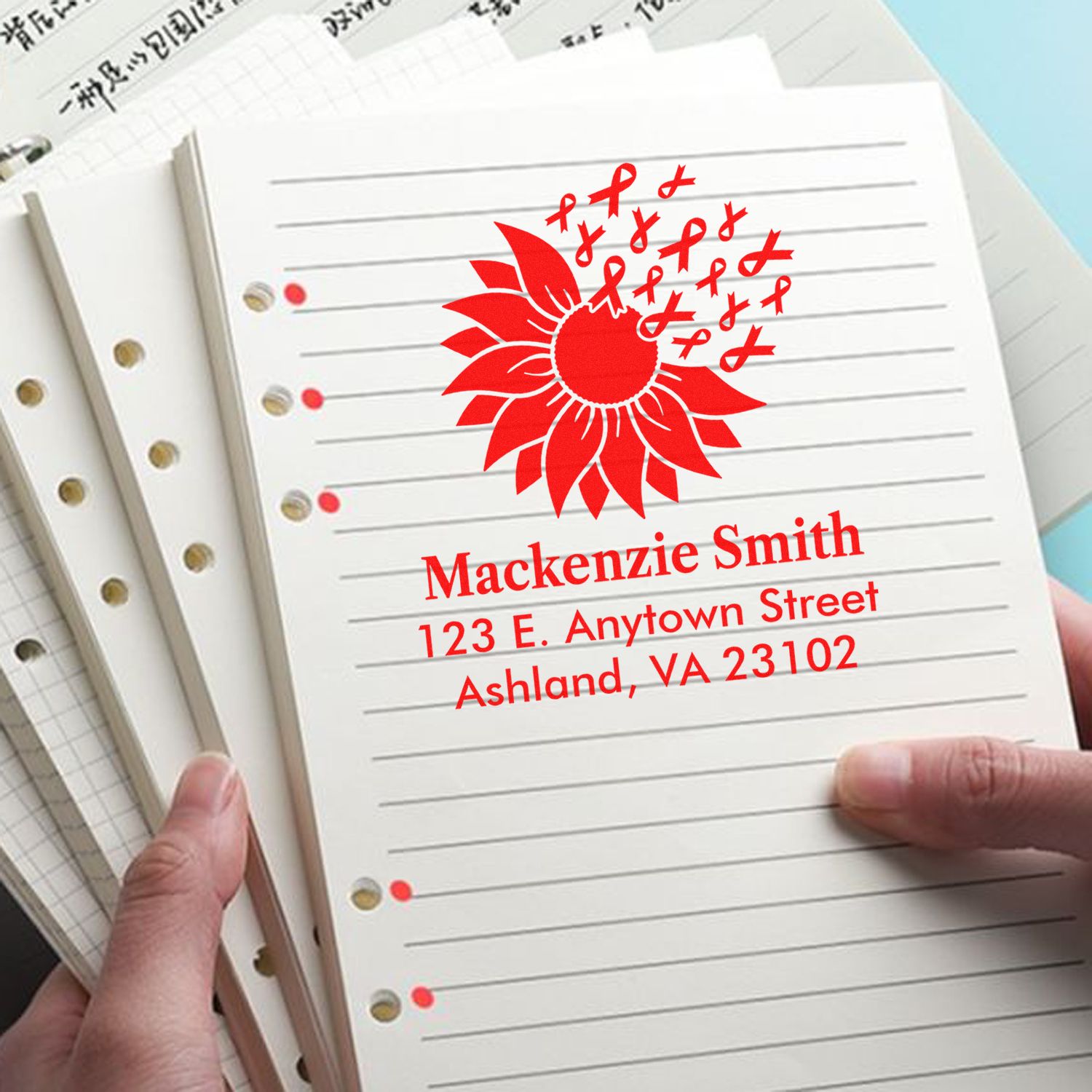 Custom rubber address stamp with sunflower and ribbon design on lined notebook paper for personalized stationery