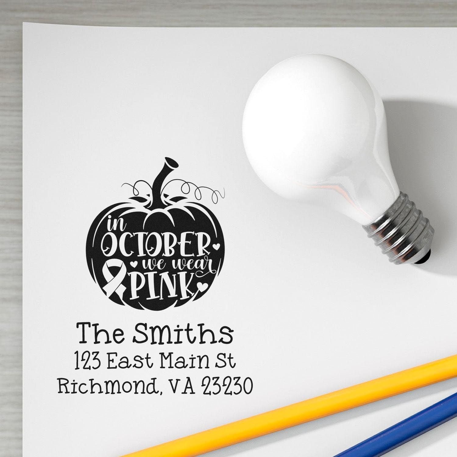 Custom address rubber stamp with October we wear pink pumpkin design for breast cancer awareness mailings.