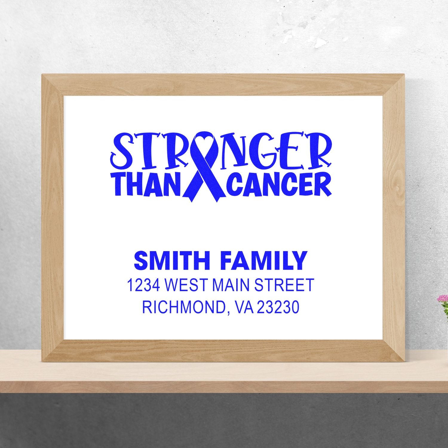 Custom rubber stamp design with blue Stronger Than Cancer ribbon and Smith Family address for personalized cancer awareness mailings.
