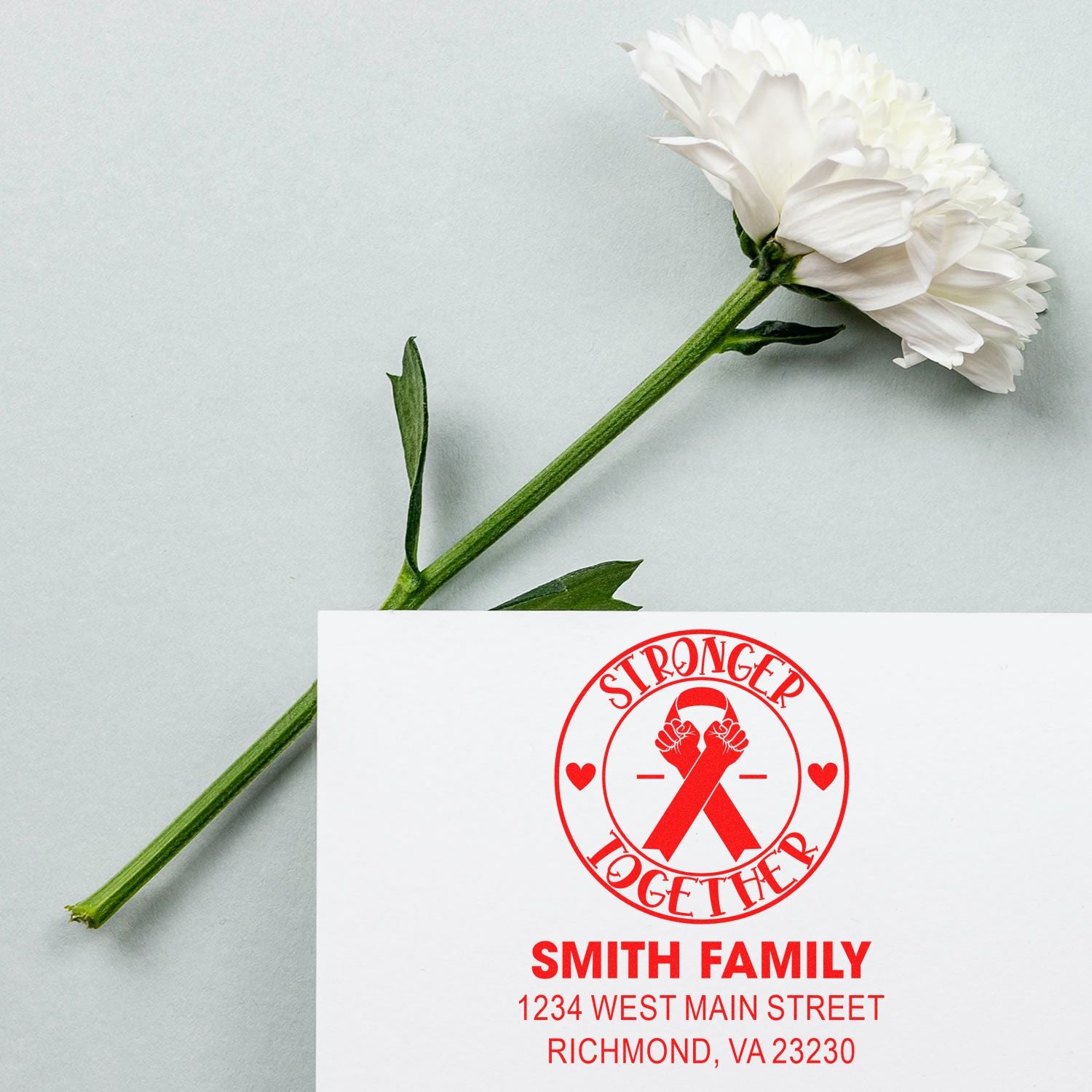 Custom rubber stamp with Stronger Together ribbon design and Smith Family return address.