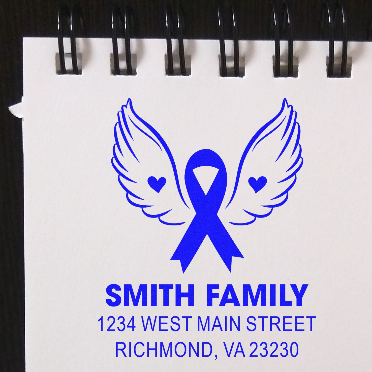 Custom rubber stamp with winged ribbon logo and Smith Family return address, Richmond, VA 23230.