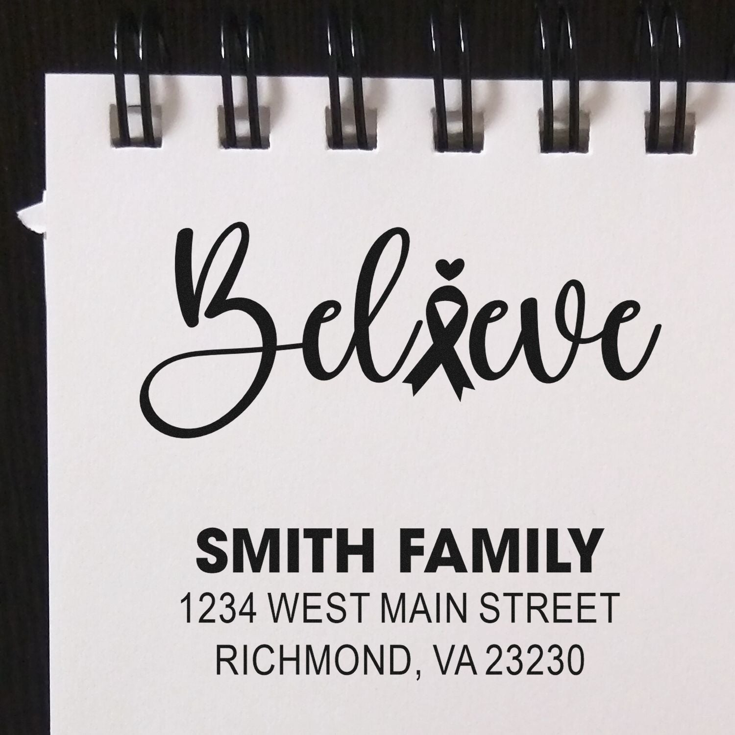 Custom rubber stamp design with Believe ribbon and Smith Family address, ideal for personalized mailing and awareness branding.