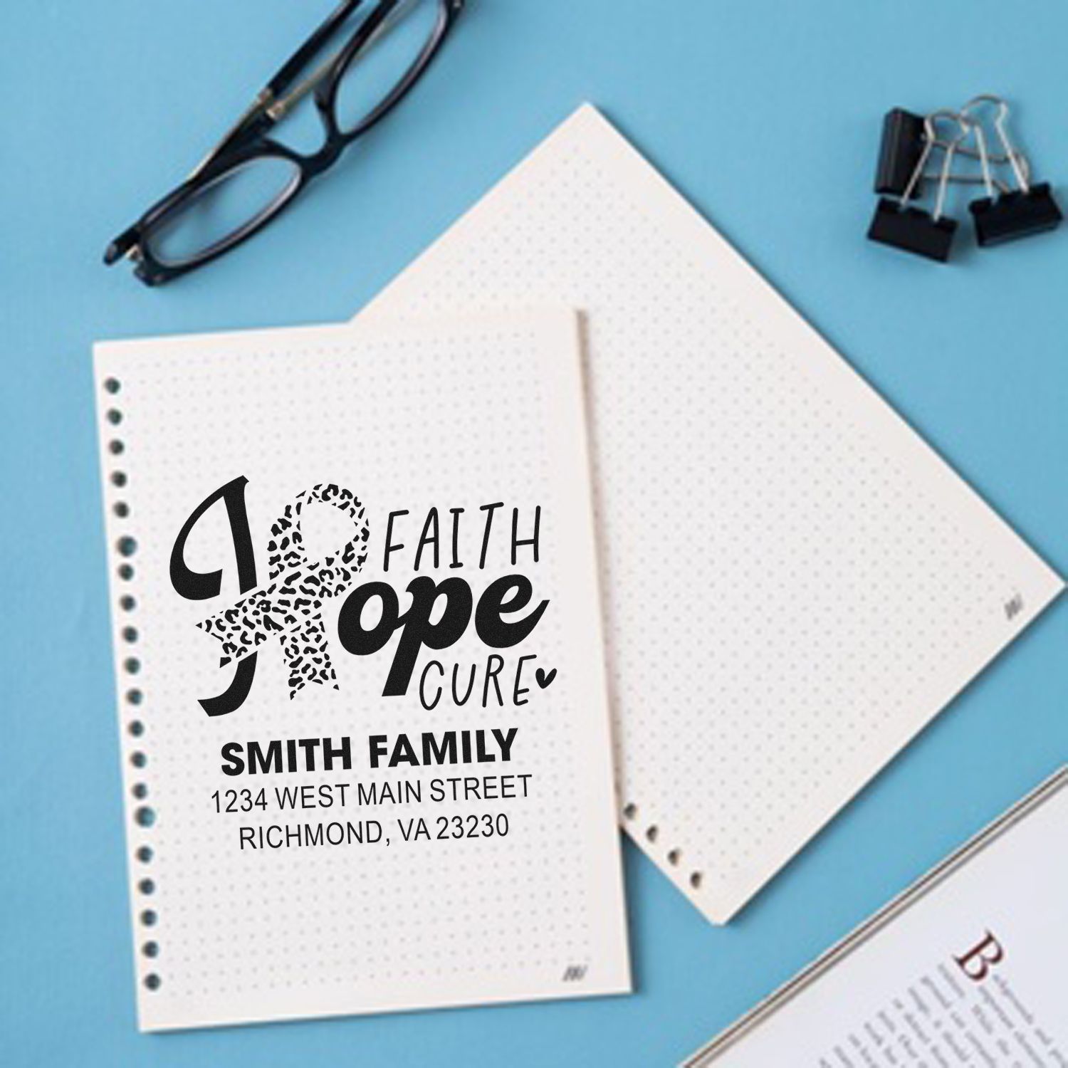 Personalized rubber stamp with Faith Hope Cure ribbon, family name, and address for cancer awareness stationery.