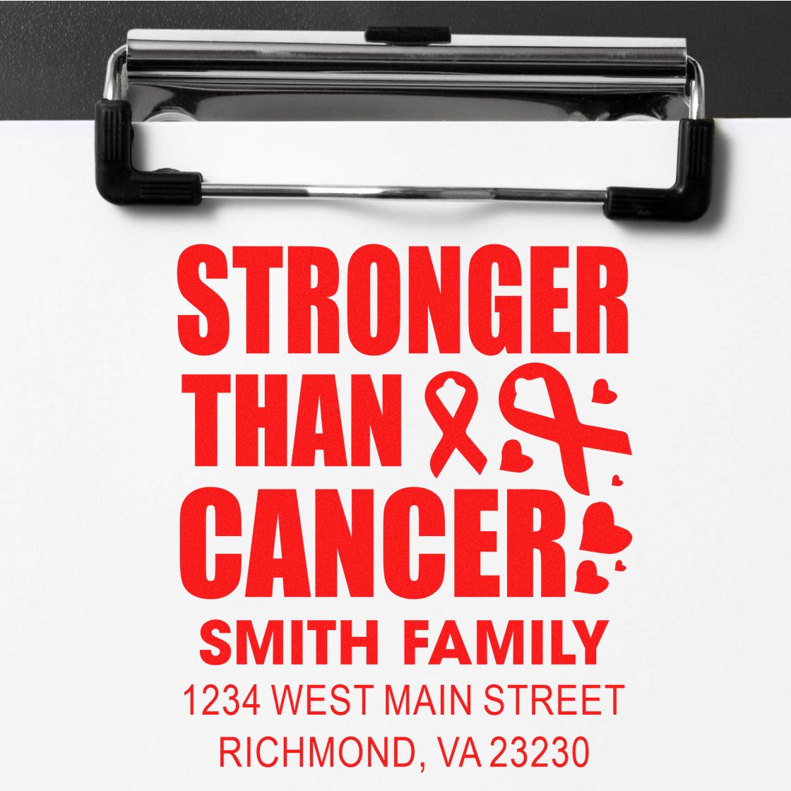 Custom rubber stamp design reading Stronger Than Cancer for Smith Family, with address in Richmond, VA, on a clipboard.