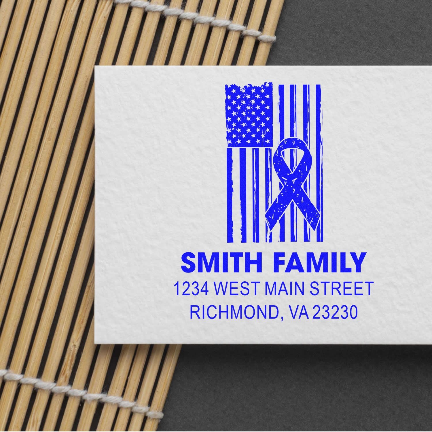 Custom blue return address rubber stamp with American flag ribbon design for personalized family envelopes.