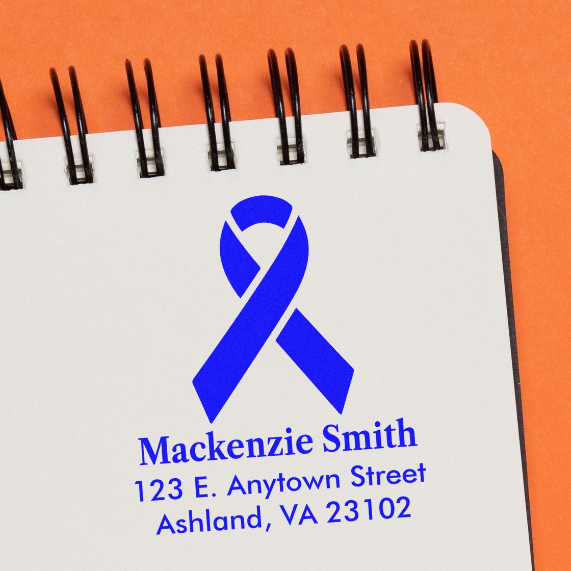 Custom blue awareness ribbon rubber stamp with name and address: Mackenzie Smith, 123 E. Anytown Street, Ashland, VA 23102.