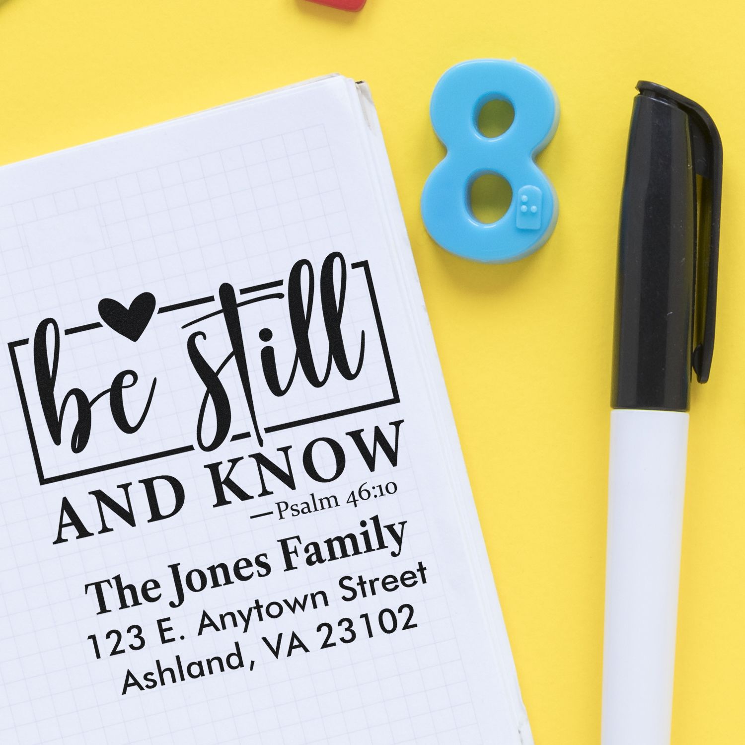Custom rubber stamp with Be Still and Know Psalm 46:10, family name, and return address for Christian mailing.