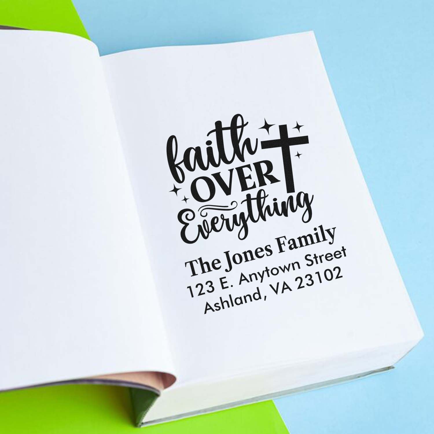 Personalized faith over everything family return address rubber stamp impression on notebook page.