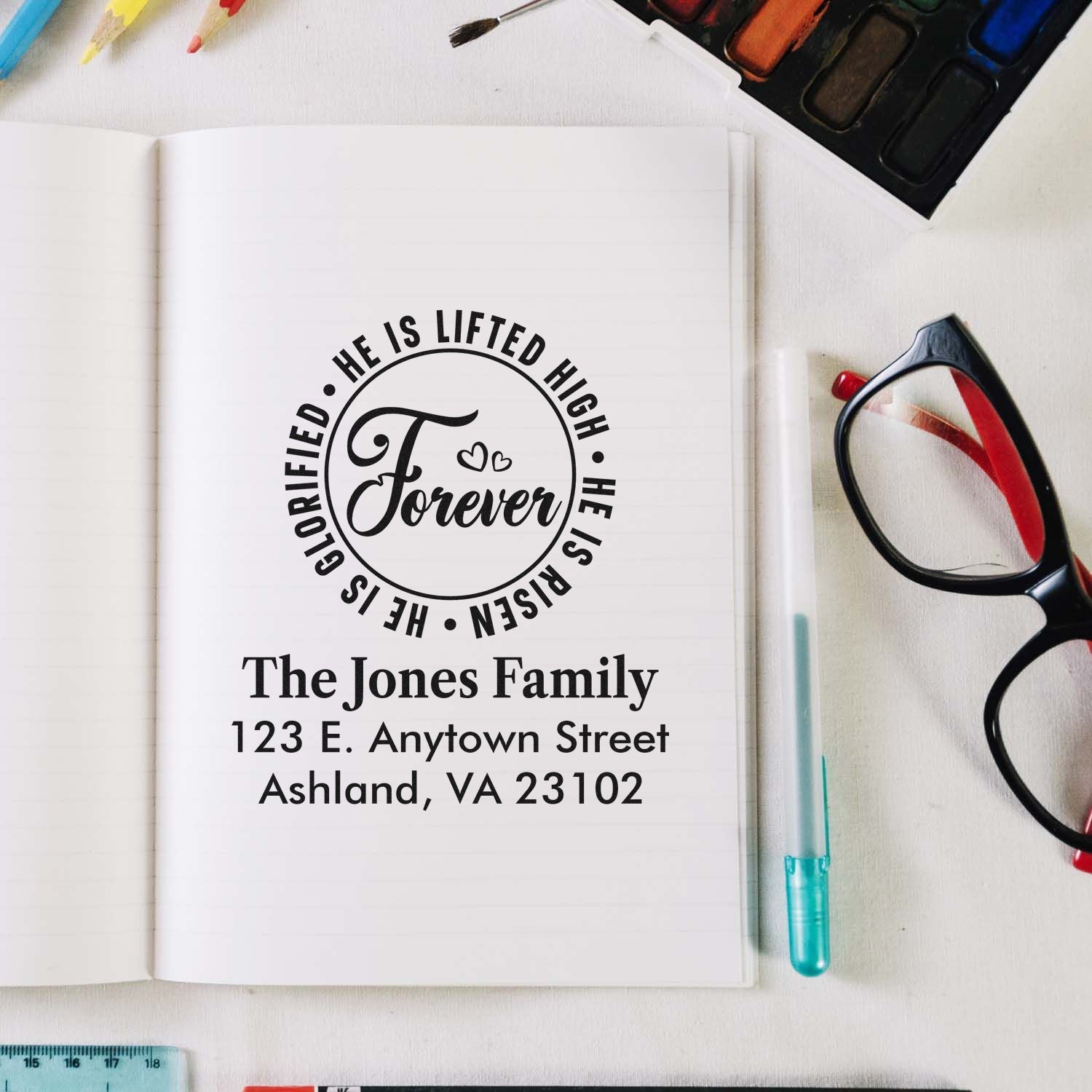 Custom rubber stamp mockup with Christian He Is Risen design and personalized family address details