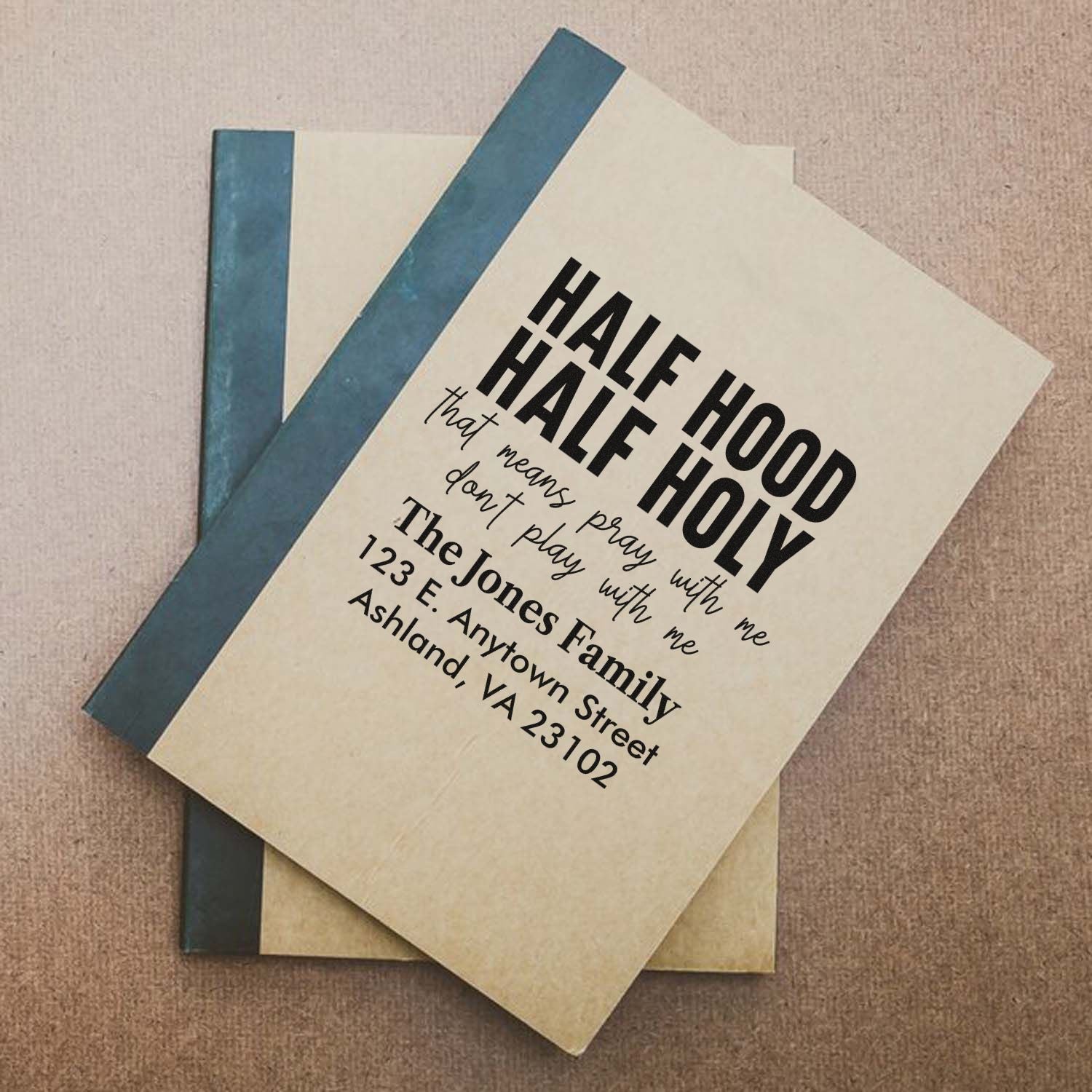 Custom rubber stamp design on a notebook cover featuring bold typography and personalized name and address.