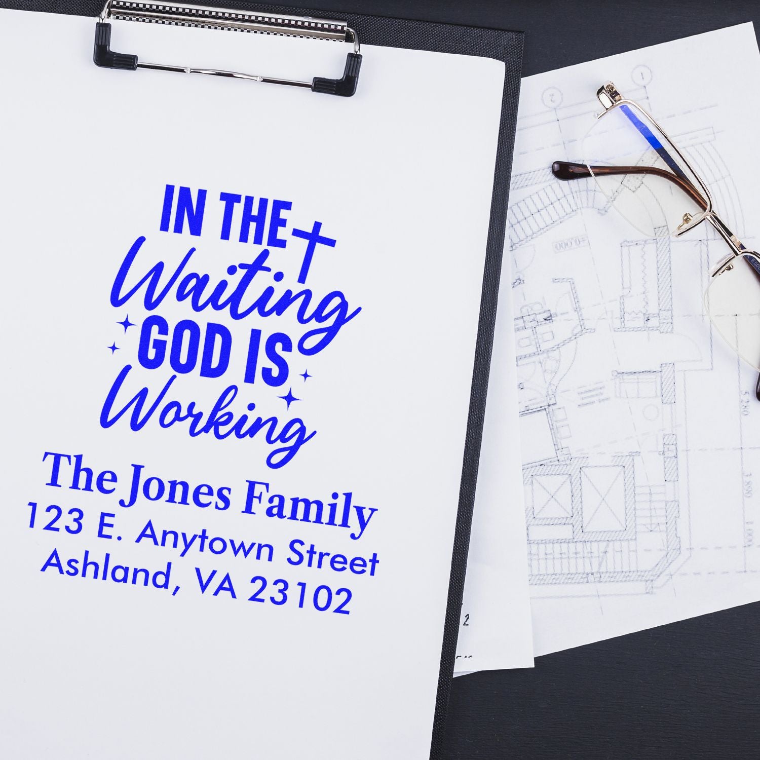 Custom rubber stamp design with faith quote In the Waiting God Is Working and personalized family return address in blue ink.