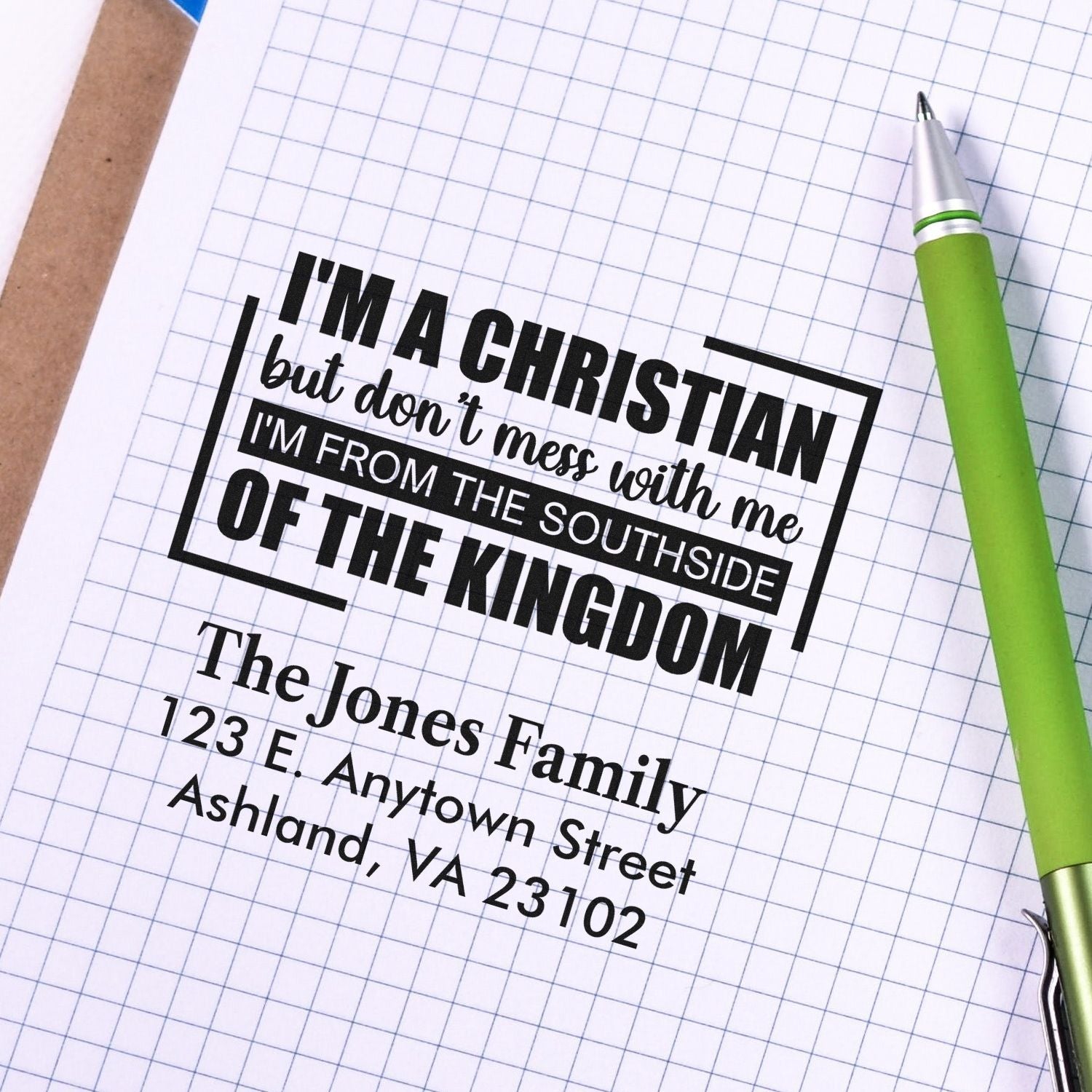 Personalized rubber stamp mockup with Christian quote, family name, and return address for custom address stamping.