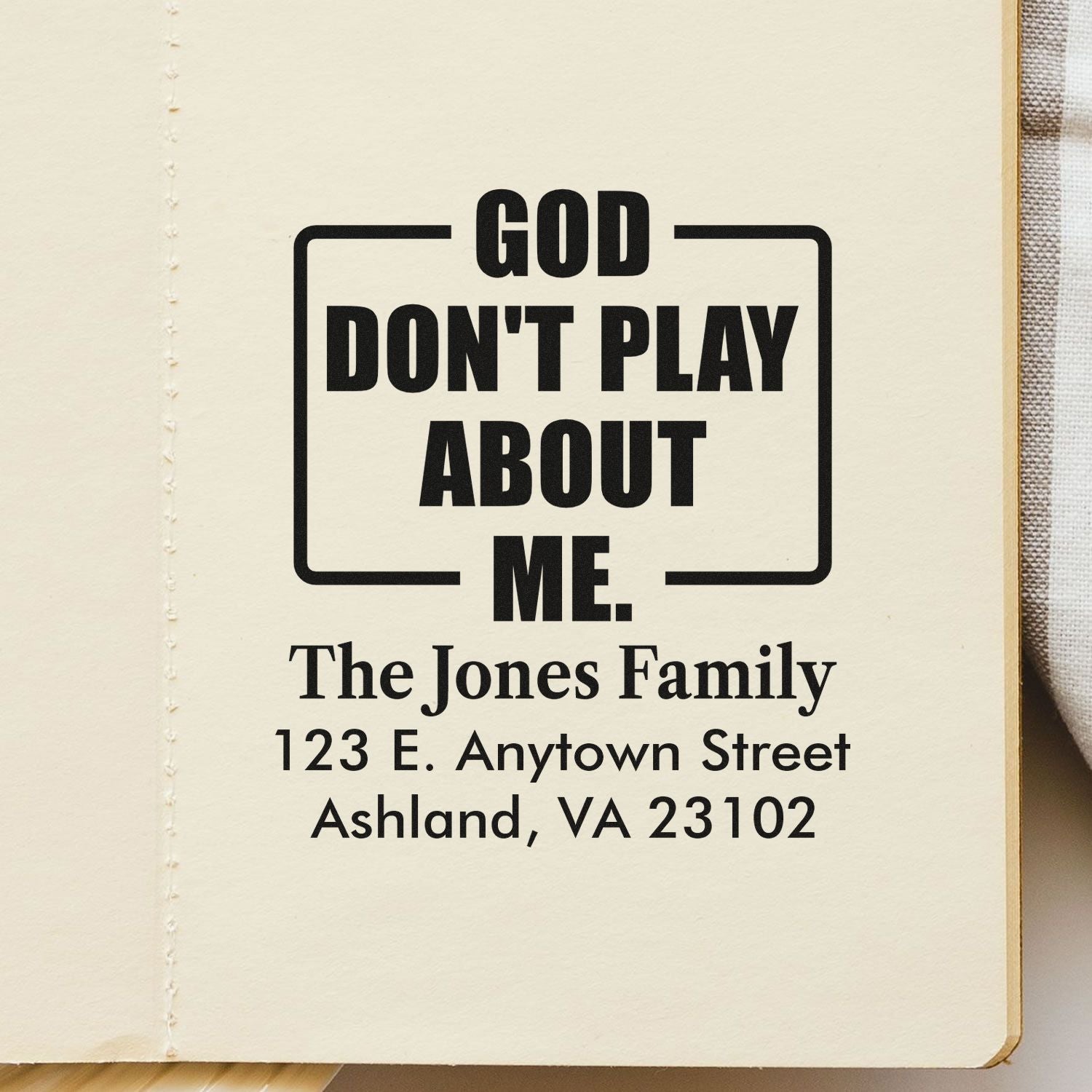 Custom rubber stamp with bold God Dont Play About Me quote and personalized The Jones Family address design.