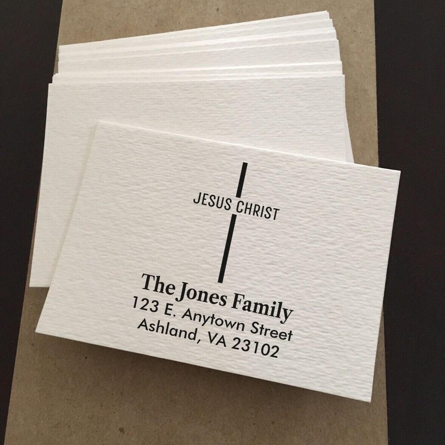 Custom Christian return address rubber stamp for The Jones Family, featuring a cross, name, and address.