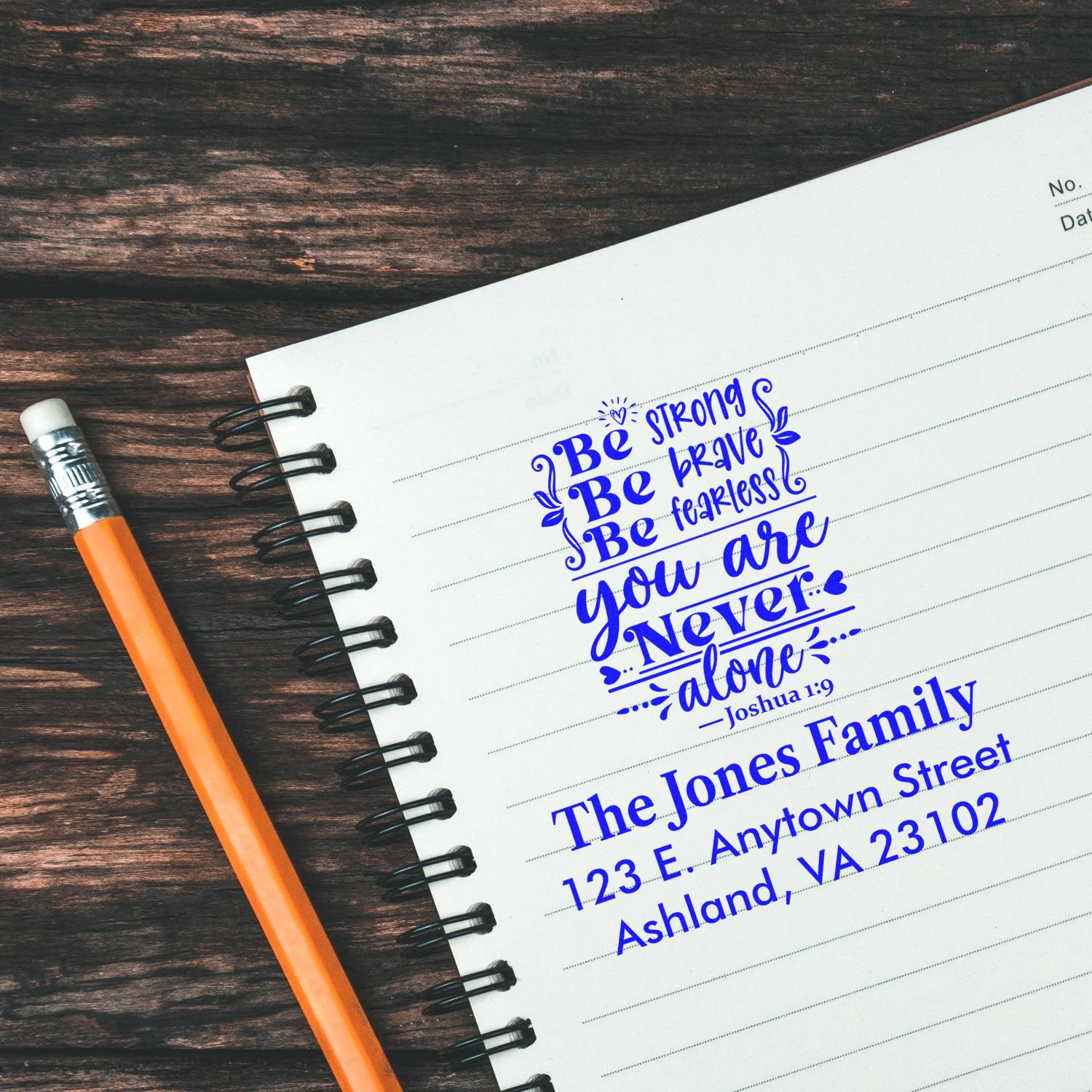 Custom rubber stamps with Bible verse Joshua 1:9 and family address on notebook paper, ideal for personalized stationery and mailings.