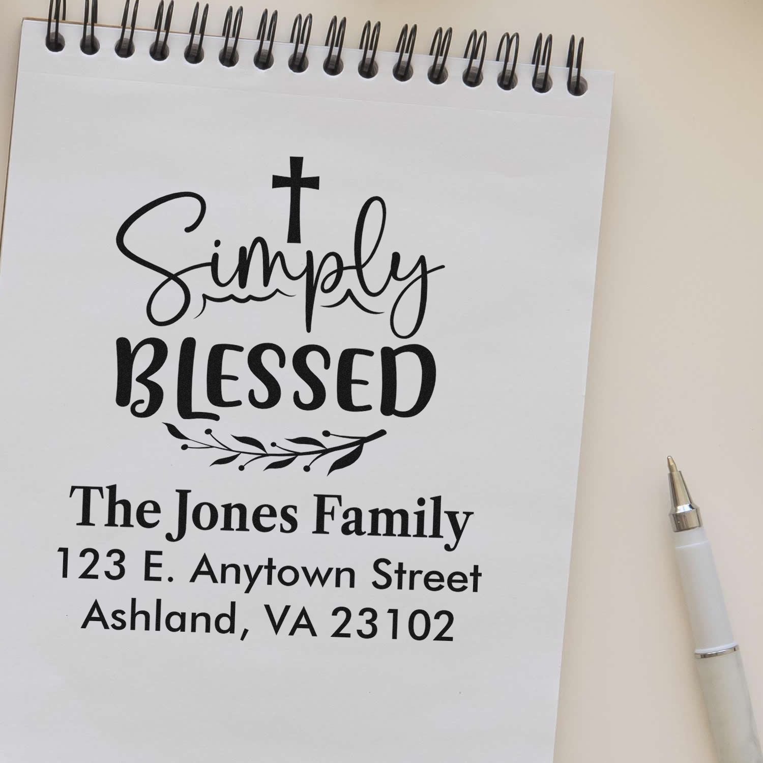 Custom personalized rubber stamp proof with cross, Simply Blessed, family name, and return address.